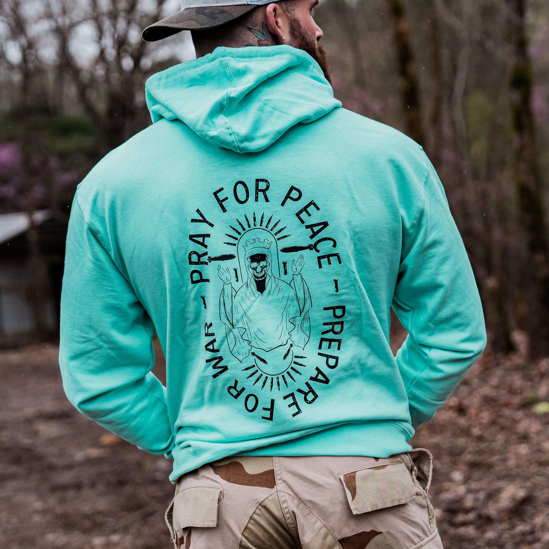 Pray for peace. Prepare for war. Midweight hoodie for men in camo with orange details #color_mint