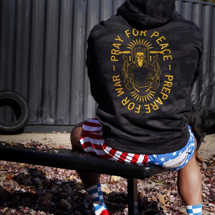 Pray for peace. Prepare for war. Midweight hoodie for men in camo with orange details #color_black-bdu-camo