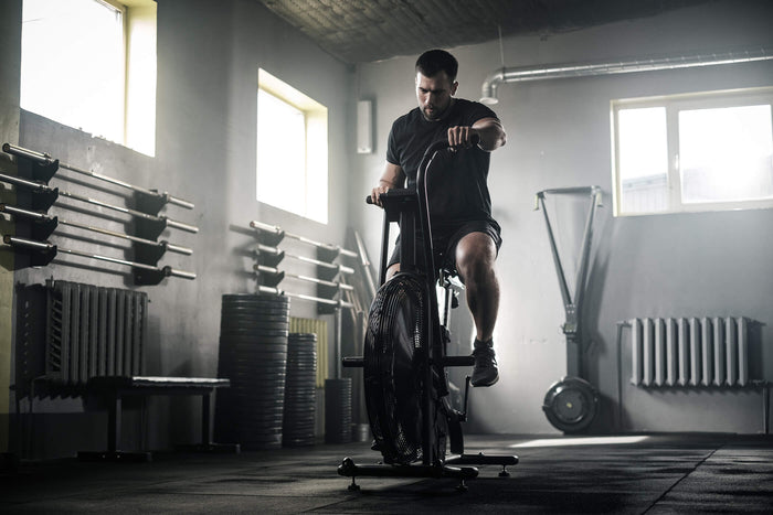 A man working out doing crossfit training on a bike