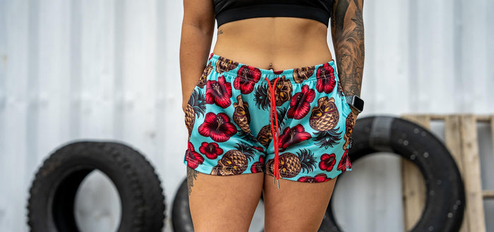 A lady athlete in combat iron mesh workout shorts.