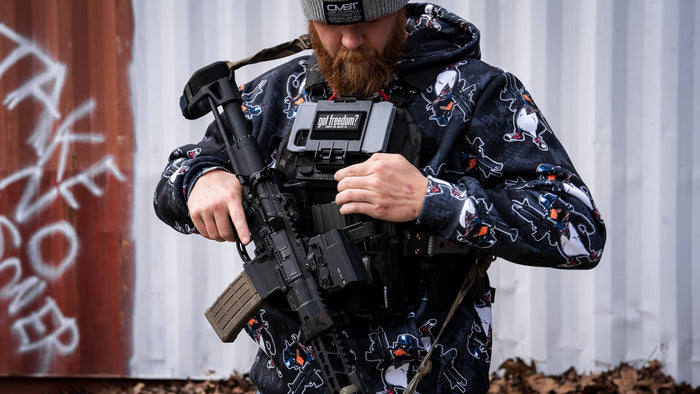 A man with outdoor gear in hoodie