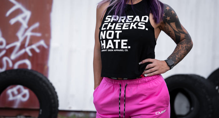 A lady with tattoos wearing Combat Iron Apparel brand clothing.