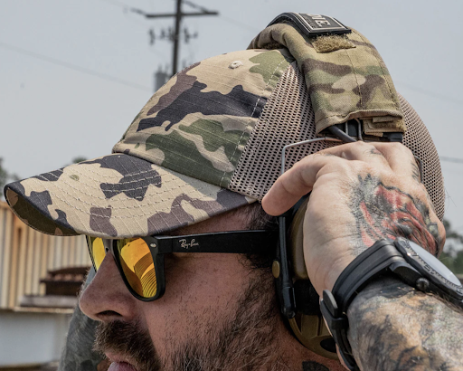 A man wearing a ripstop-style tactical hat.