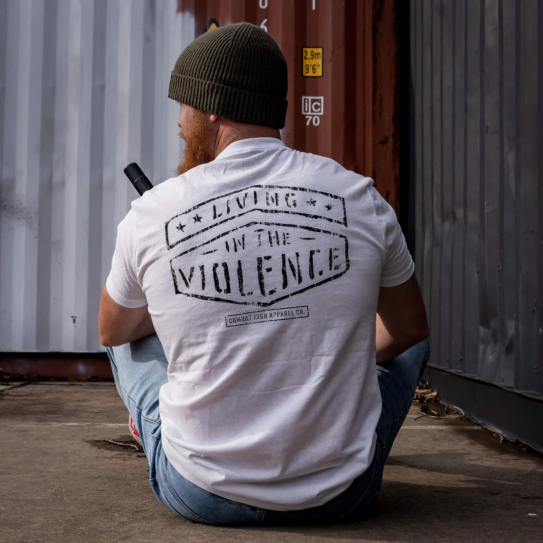 Veteran wearing a white Combat Iron Apparel patriotic style t-shirt while wearing a beanie. 