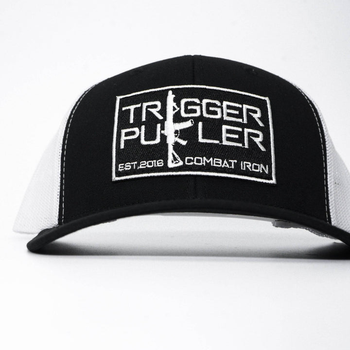 A mid-profile mesh snapback with the words “Trigger puller” on the front in white #color_black-white