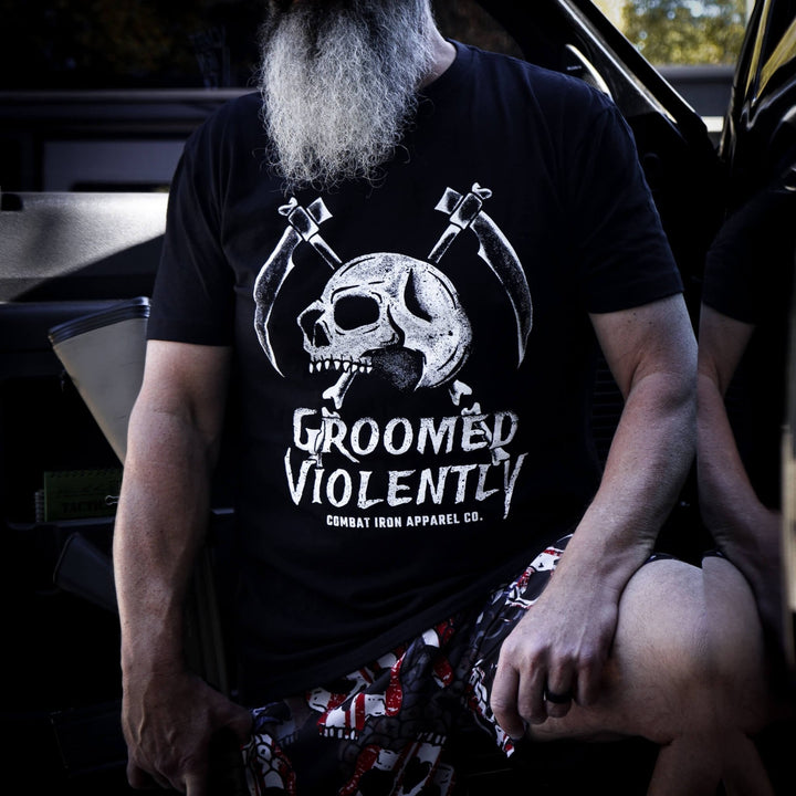 Men’s black t-shirt with the words “Groomed violently” with a skull and two sickles on the front #color_black