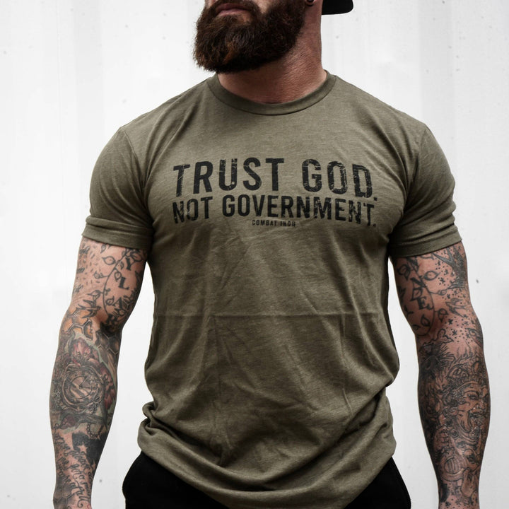 Men’s black t-shirt with the message “Trust God. Not government.” with letters and a American flag on the sleeve #color_military-green