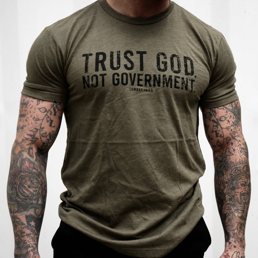 Men’s black t-shirt with the message “Trust God. Not government.” with letters and a American flag on the sleeve #color_military-green