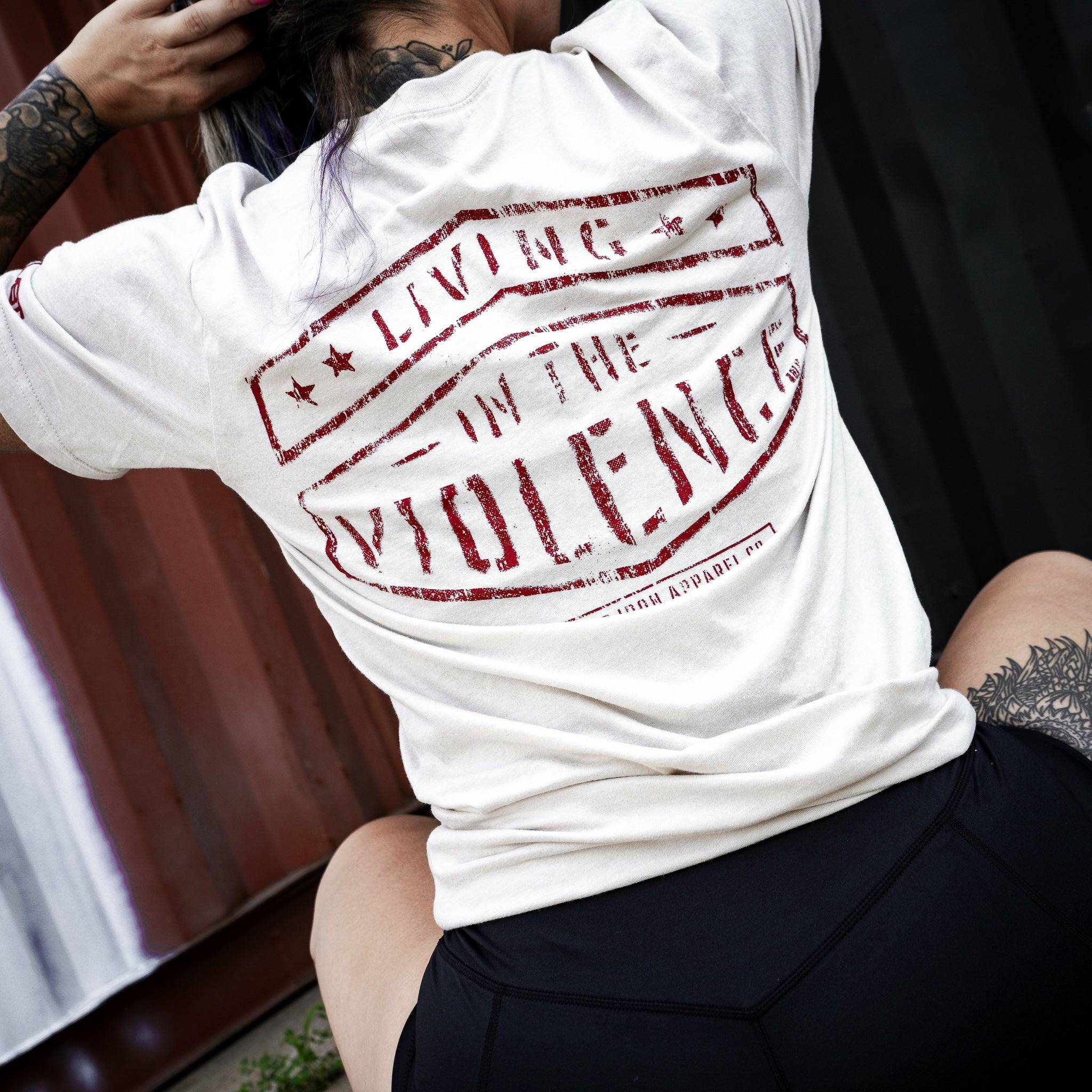 Men’s t-shirt with the words “Living in the violence” #color_tan