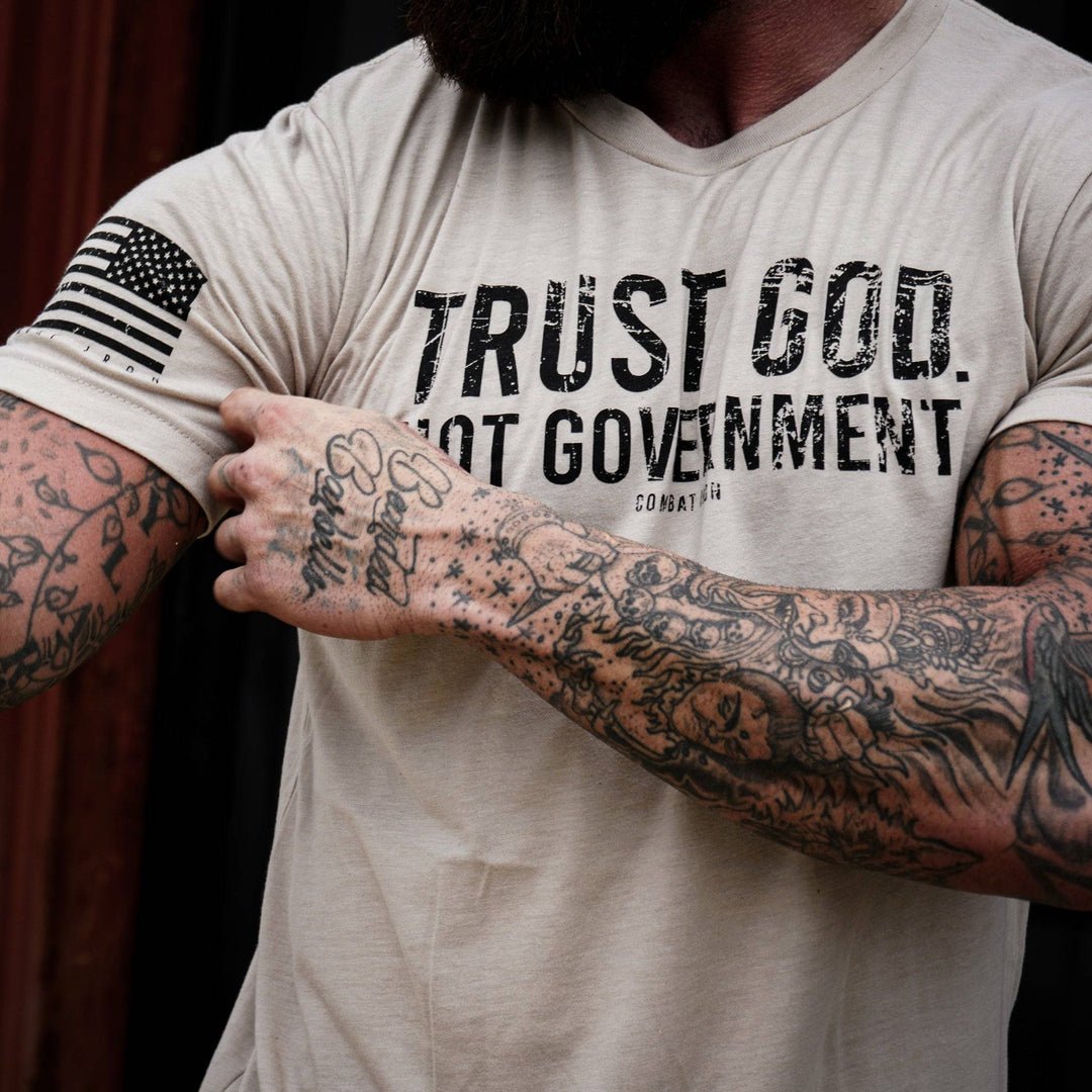 Men’s black t-shirt with the message “Trust God. Not government.” with letters and a American flag on the sleeve #color_tan