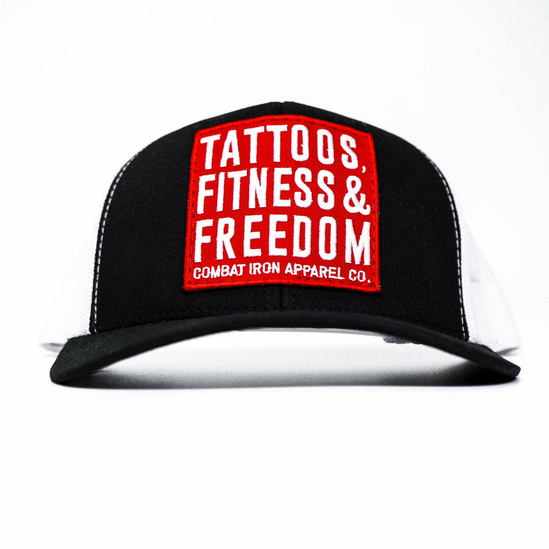 A black mid-profile mesh snapback with a red patch saying “Tattoos, fitness & freedom” in white letters #color_black-white