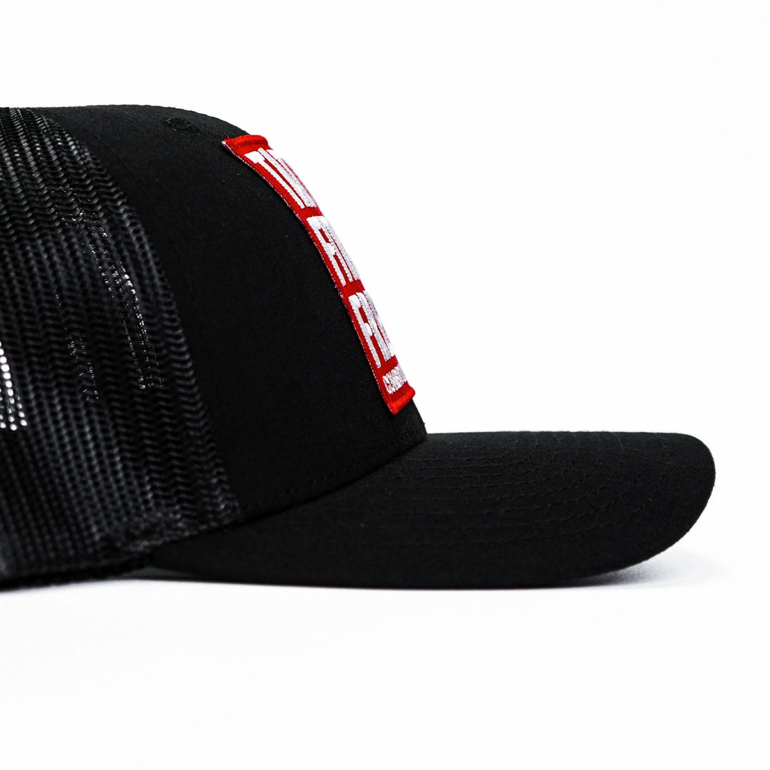 A black mid-profile mesh snapback with a red patch saying “Tattoos, fitness & freedom” in white letters #color_black-black