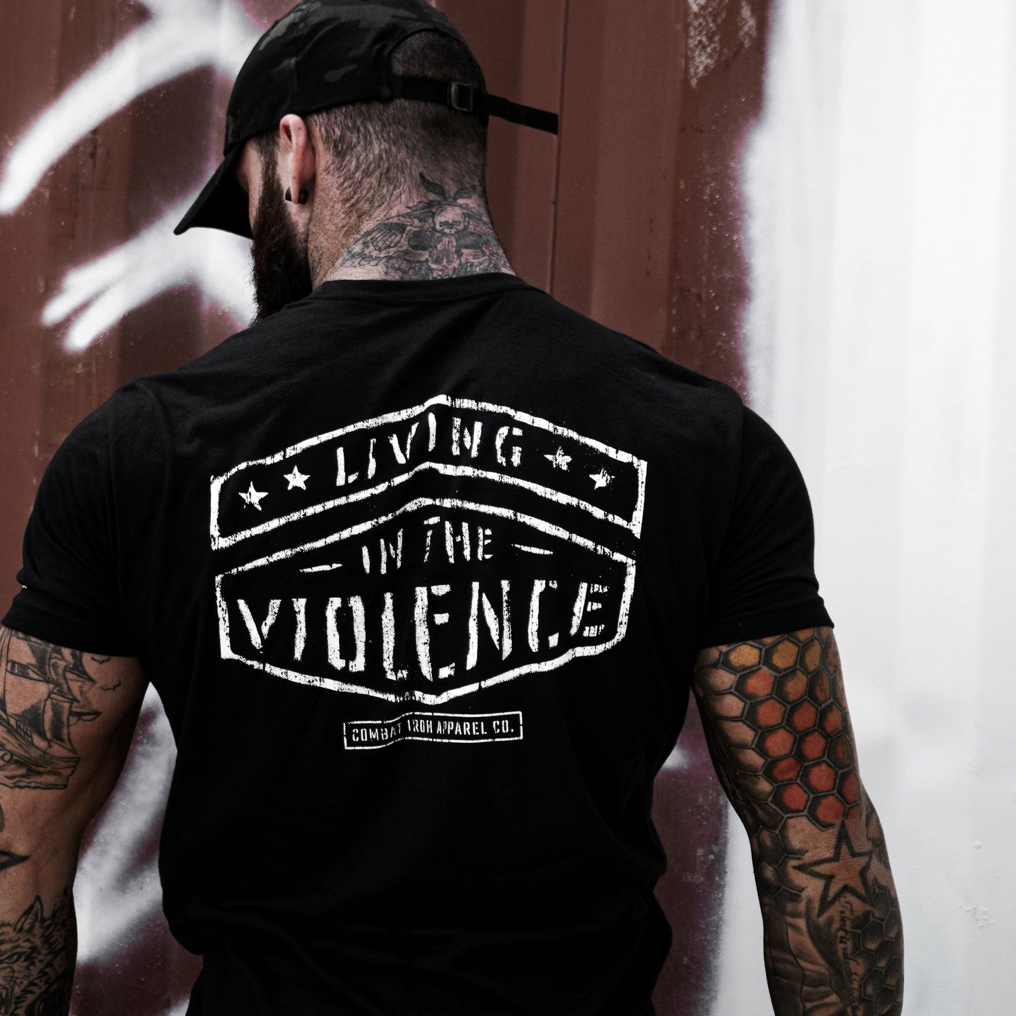 Men’s black t-shirt with the words “Living in the violence” #color_black