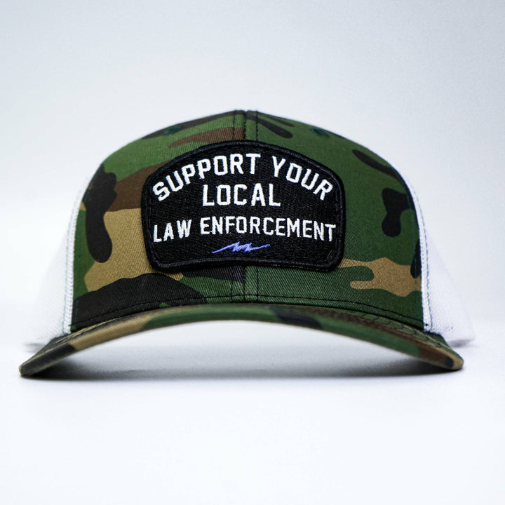 A mid-profile snapback hat with a patch on the front that says “Support your local law enforcement” #color_bdu-camo-white