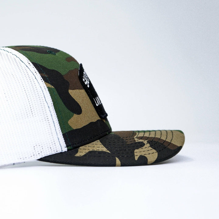 A mid-profile snapback hat with a patch on the front that says “Support your local law enforcement” #color_bdu-camo-white