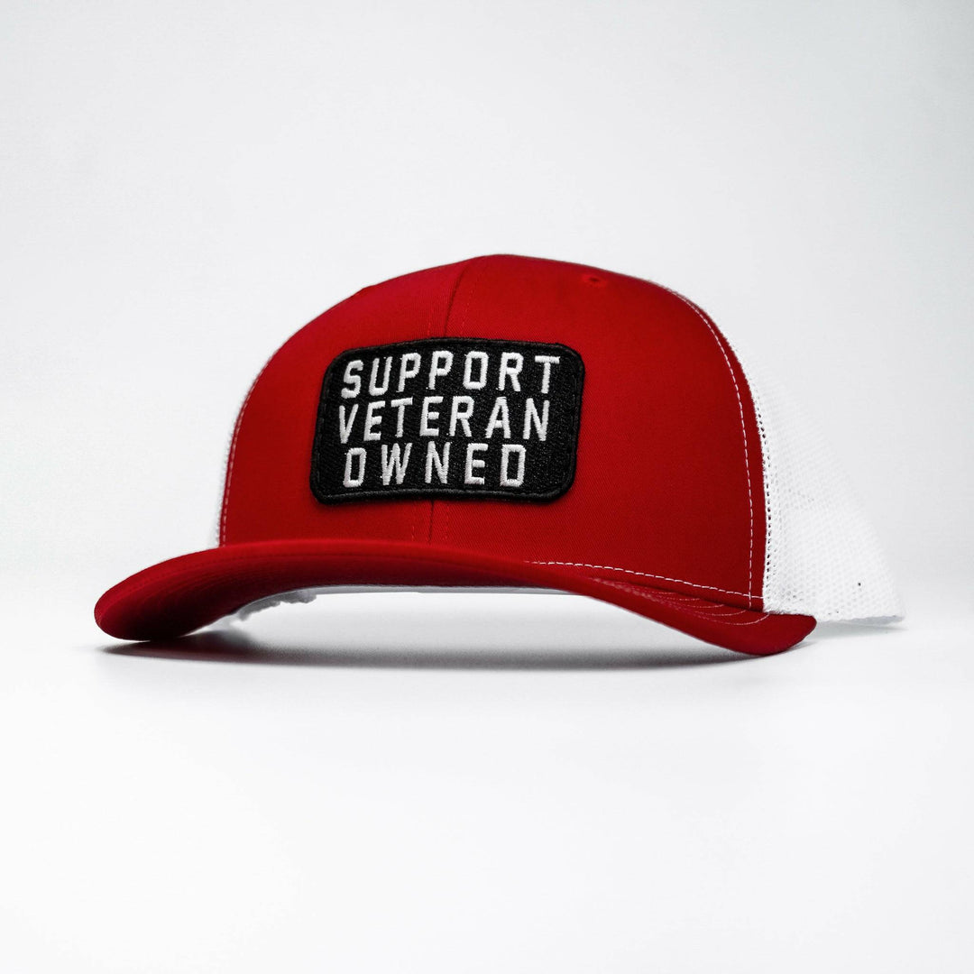 A mid-profile mesh snapback with a patch that says “Support veteran owned” in white letters #color_red-white