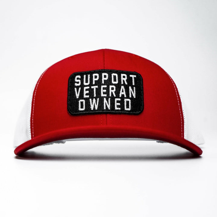 A mid-profile mesh snapback with a patch that says “Support veteran owned” in white letters #color_red-white