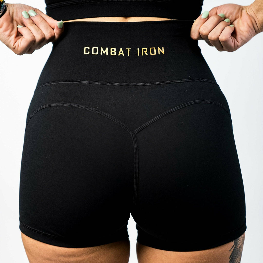 Ladies' luxe high-waisted shorts for women, all black with the CMBT logo #color_black