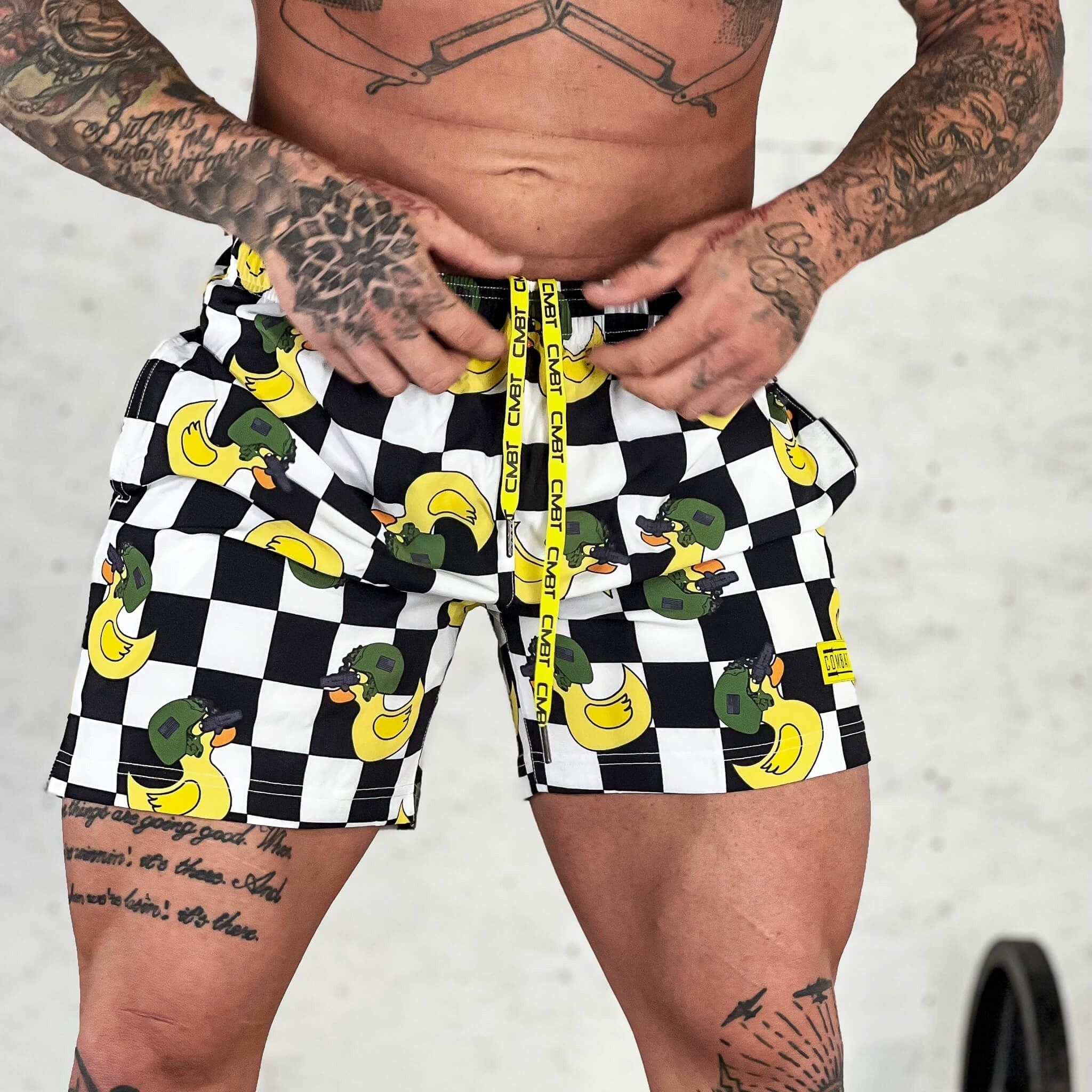 Men’s performance training shorts with black and white checkered design and ducks #color_tactiduck-checkered-edition