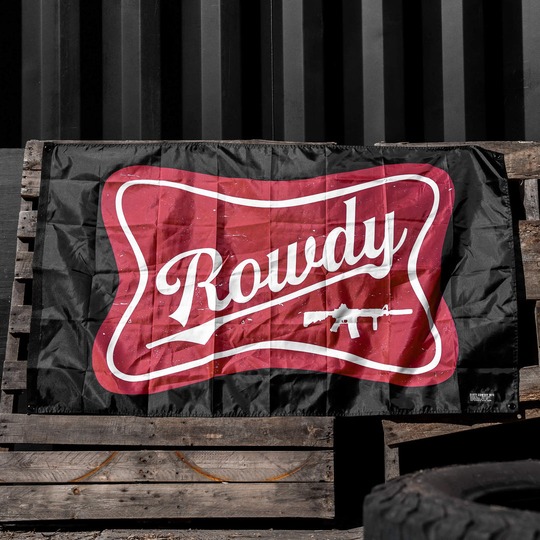 Red and white 'Rowdy' logo on a black background, displayed on a wooden crate.