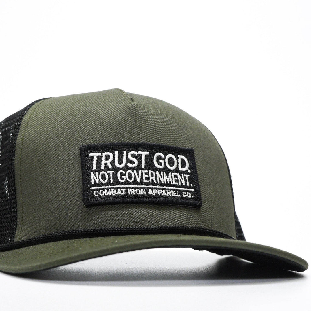 A retro rope snapback with a patch that says “Trust god. Not government” #color_military-green-black