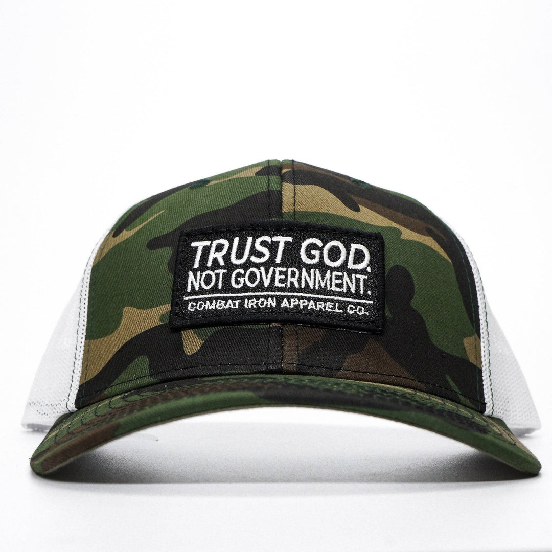 A mid-profile mesh snapback with the words “Trust God. Not government.” in white on the front #color_bdu-camo-white