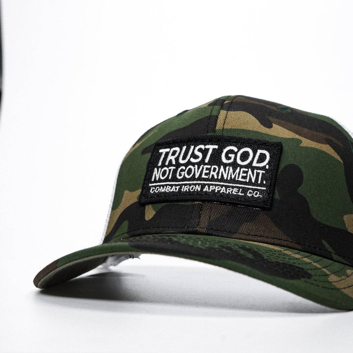 A mid-profile mesh snapback with the words “Trust God. Not government.” in white on the front #color_camo-white