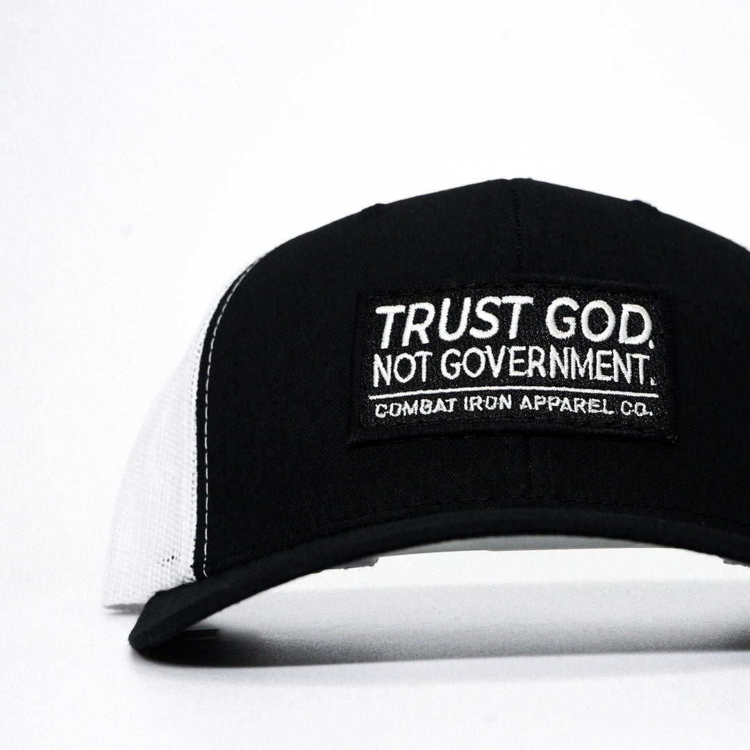 A black mid-profile mesh snapback with the words “Trust God. Not government.” in white on the front #color_black-white