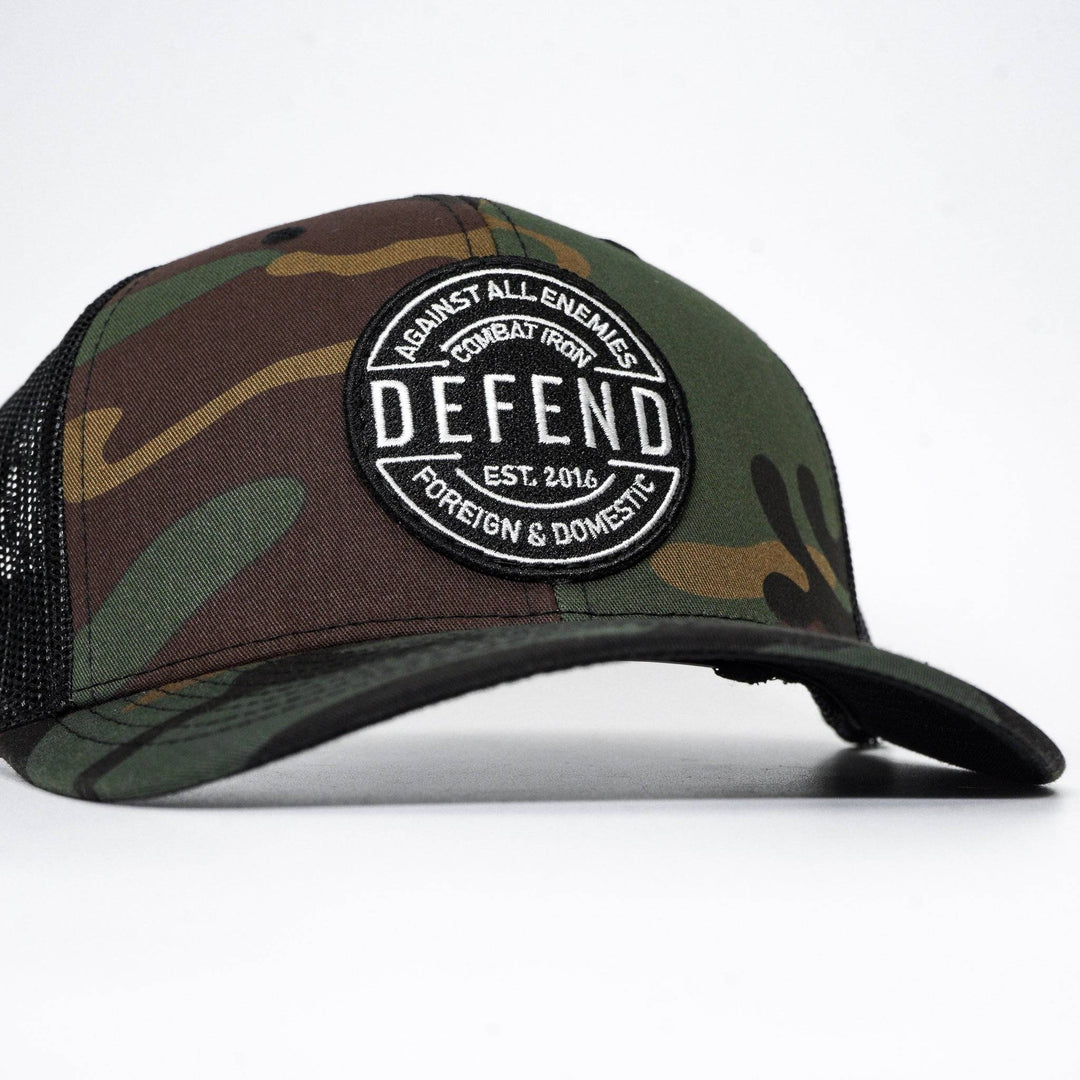 A camo retro rope snapback with the words “Defend against all enemies, foreign & domestic” on the front #color_bdu-black
