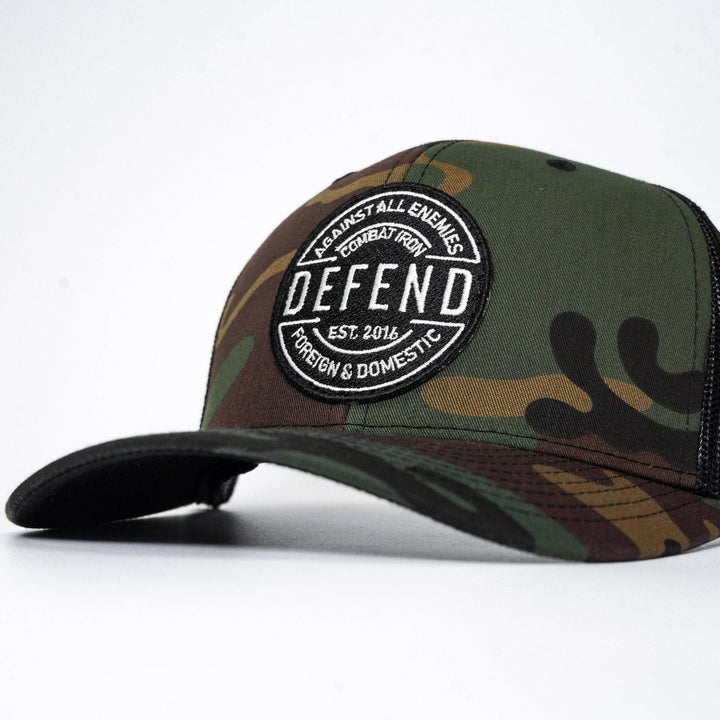 A camo retro rope snapback with the words “Defend against all enemies, foreign & domestic” on the front #color_bdu-black