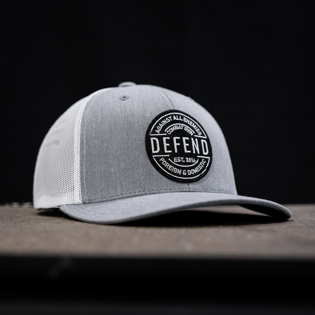 A retro rope snapback with the words “Defend against all enemies, foreign & domestic” on the front #color_gray-white