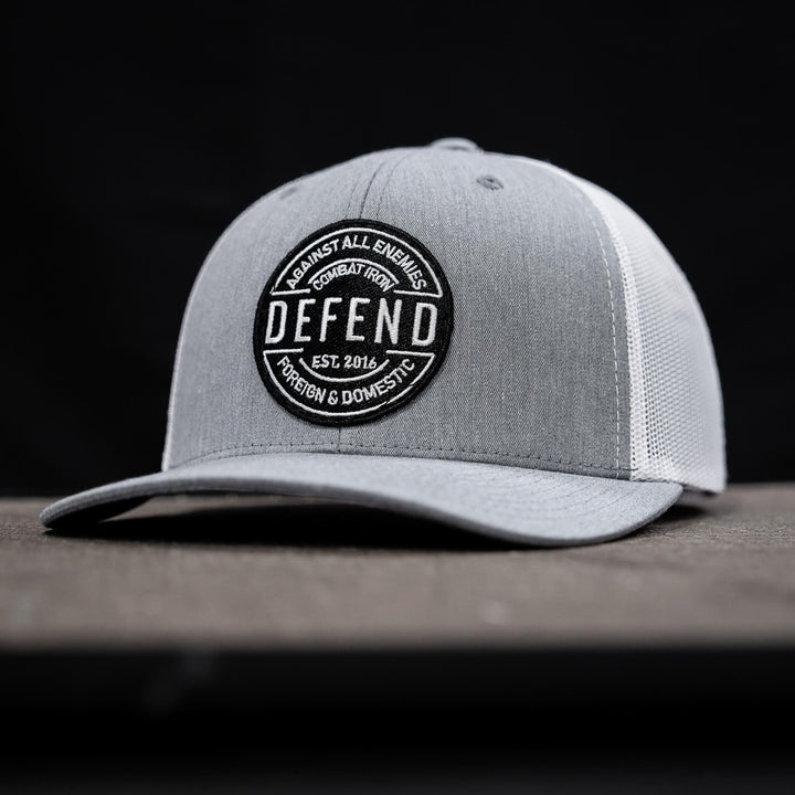 A retro rope snapback with the words “Defend against all enemies, foreign & domestic” on the front #color_gray-white