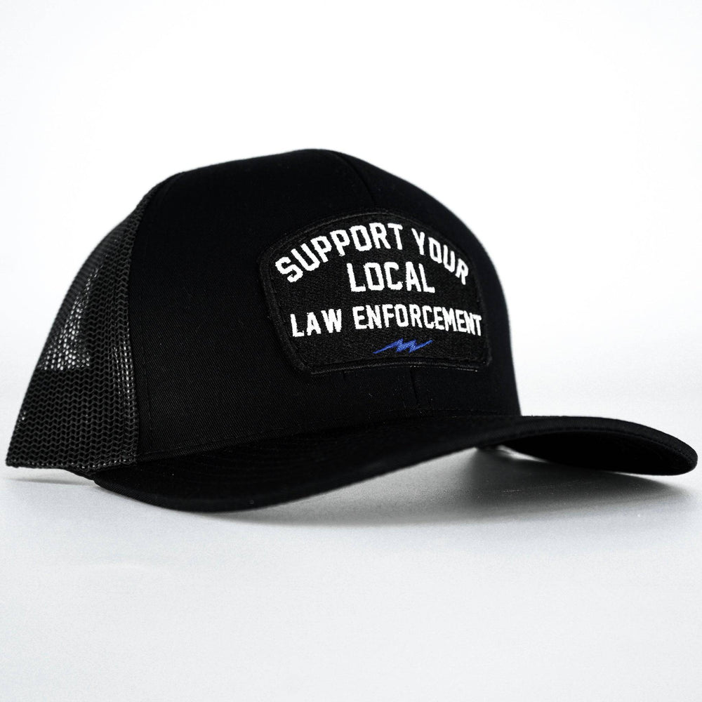 A black mid-profile snapback hat with a patch on the front that says “Support your local law enforcement” #color_black-black