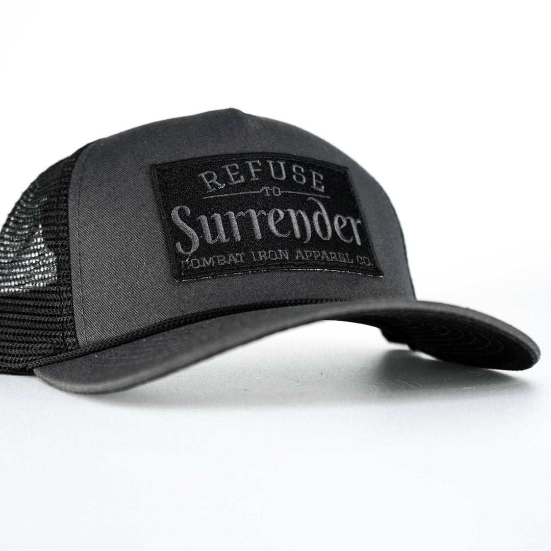 A camo retro rope snapback with a black patch that says “Refuse to surrender” #color_gun-metal-gray-black