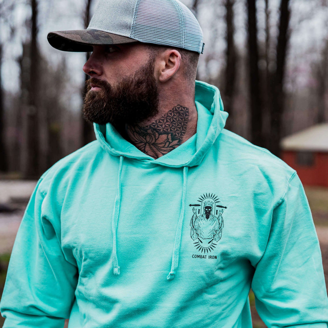 Pray for peace. Prepare for war. Midweight hoodie for men in camo with orange details #color_mint