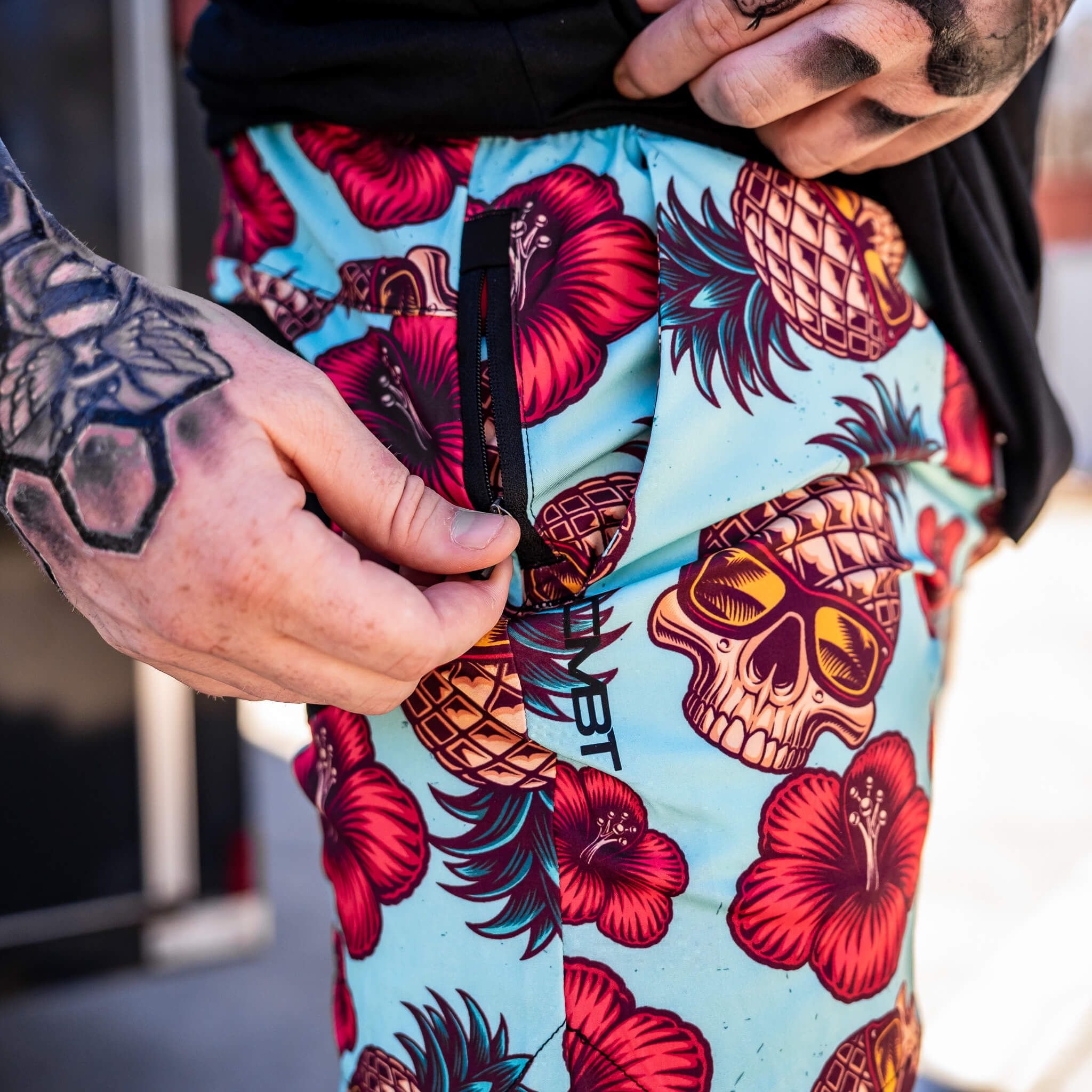 Men’s hybrid training and swim shorts with skulls, pineapples, and flowers #color_teal-pineapple-express