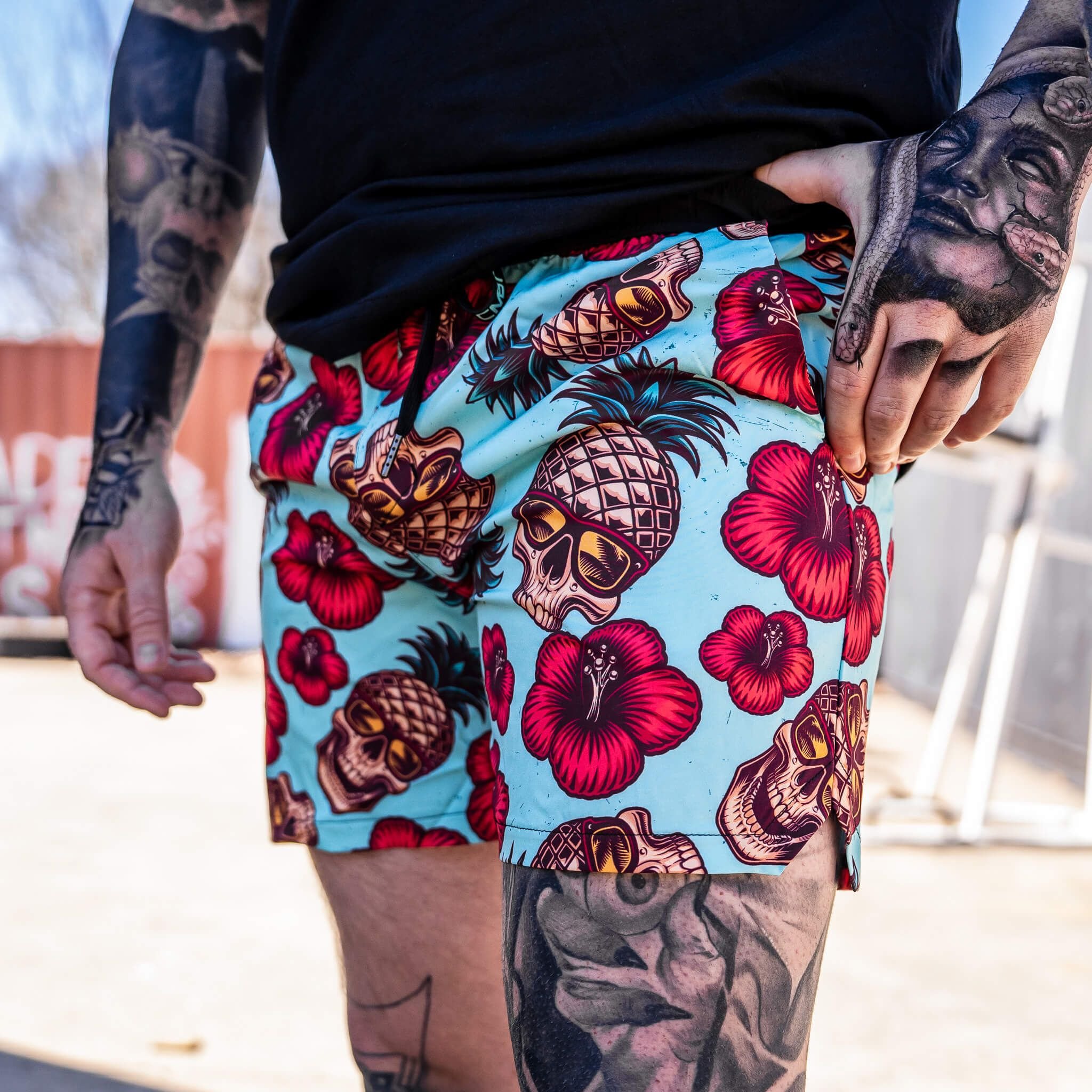 Men’s hybrid training and swim shorts with skulls, pineapples, and flowers #color_teal-pineapple-express