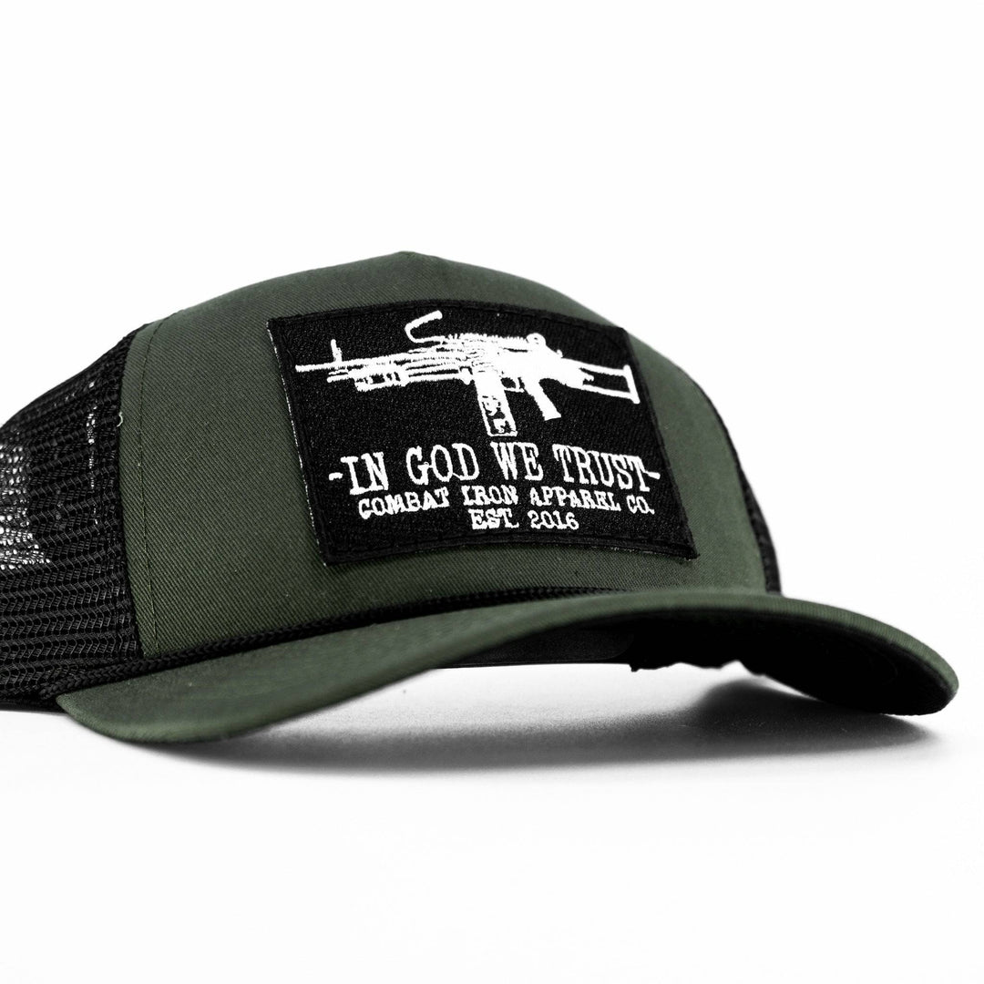 A camo retro rope snapback with a black patch saying “In God we trust” in white letters and an LMG on it #color_military-green-black