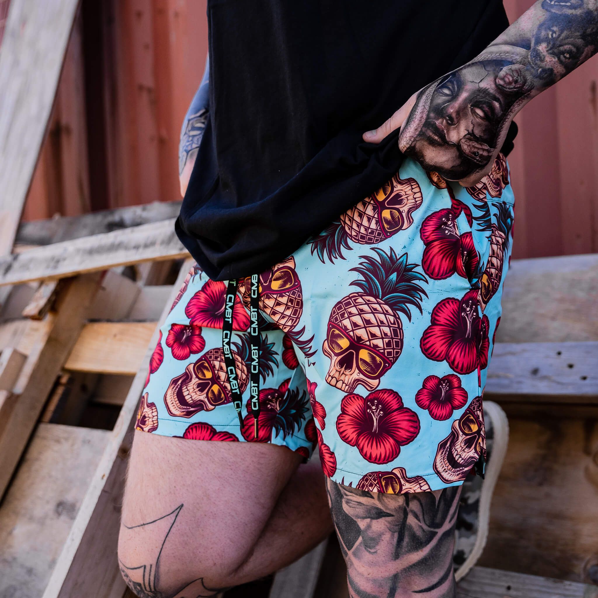 Men’s hybrid training and swim shorts with skulls, pineapples, and flowers #color_teal-pineapple-express