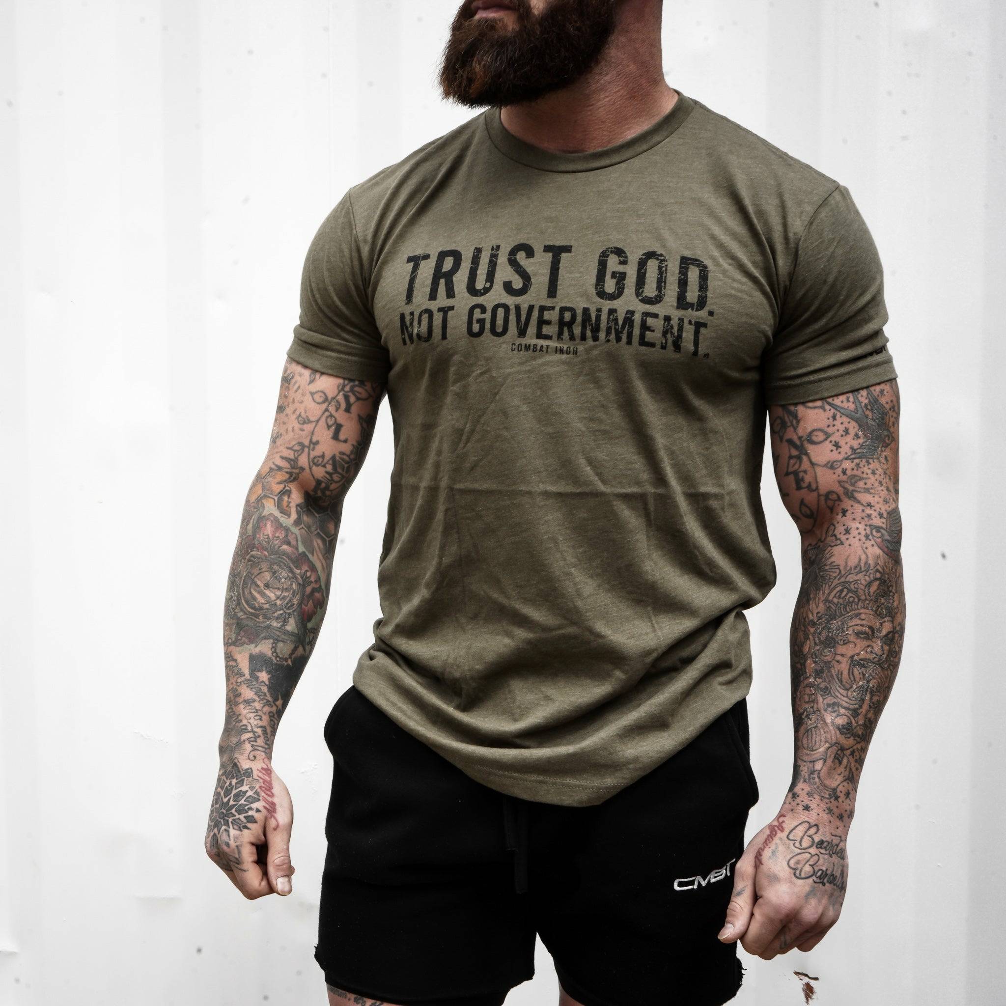 Men’s black t-shirt with the message “Trust God. Not government.” with letters and a American flag on the sleeve #color_military-green