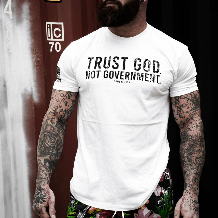 Men’s black t-shirt with the message “Trust God. Not government.” with letters and a American flag on the sleeve #color_white