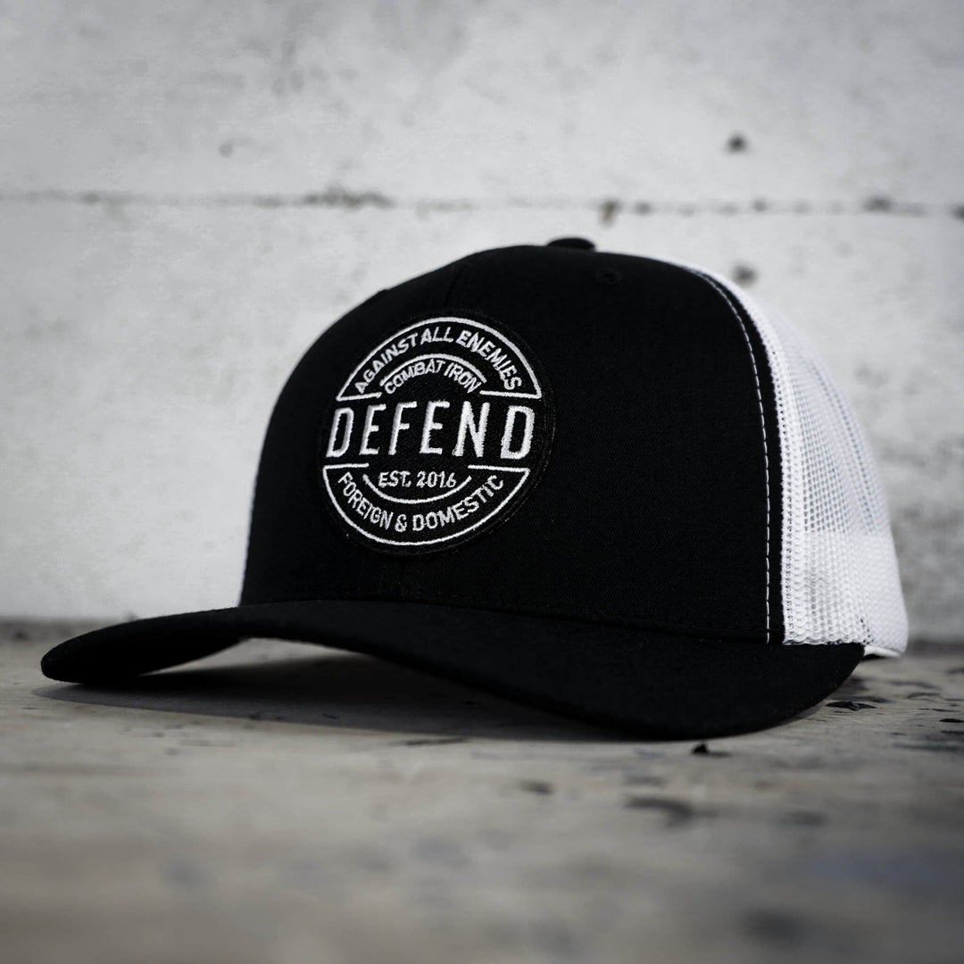 A retro rope snapback with the words “Defend against all enemies, foreign & domestic” on the front #color_black-white