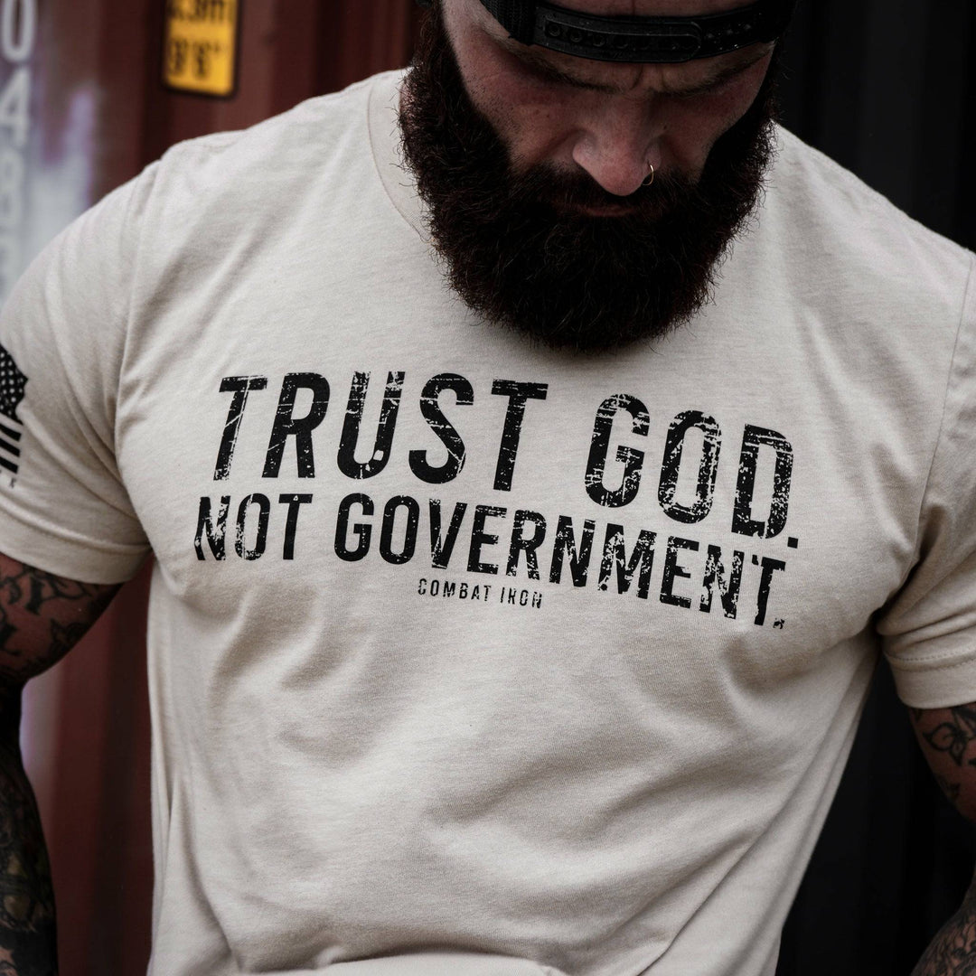 Men’s black t-shirt with the message “Trust God. Not government.” with letters and a American flag on the sleeve #color_tan