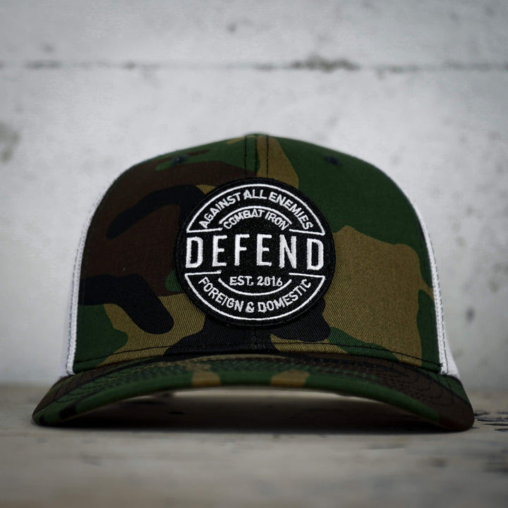 A retro rope snapback with the words “Defend against all enemies, foreign & domestic” on the front #color_bdu-camo-white