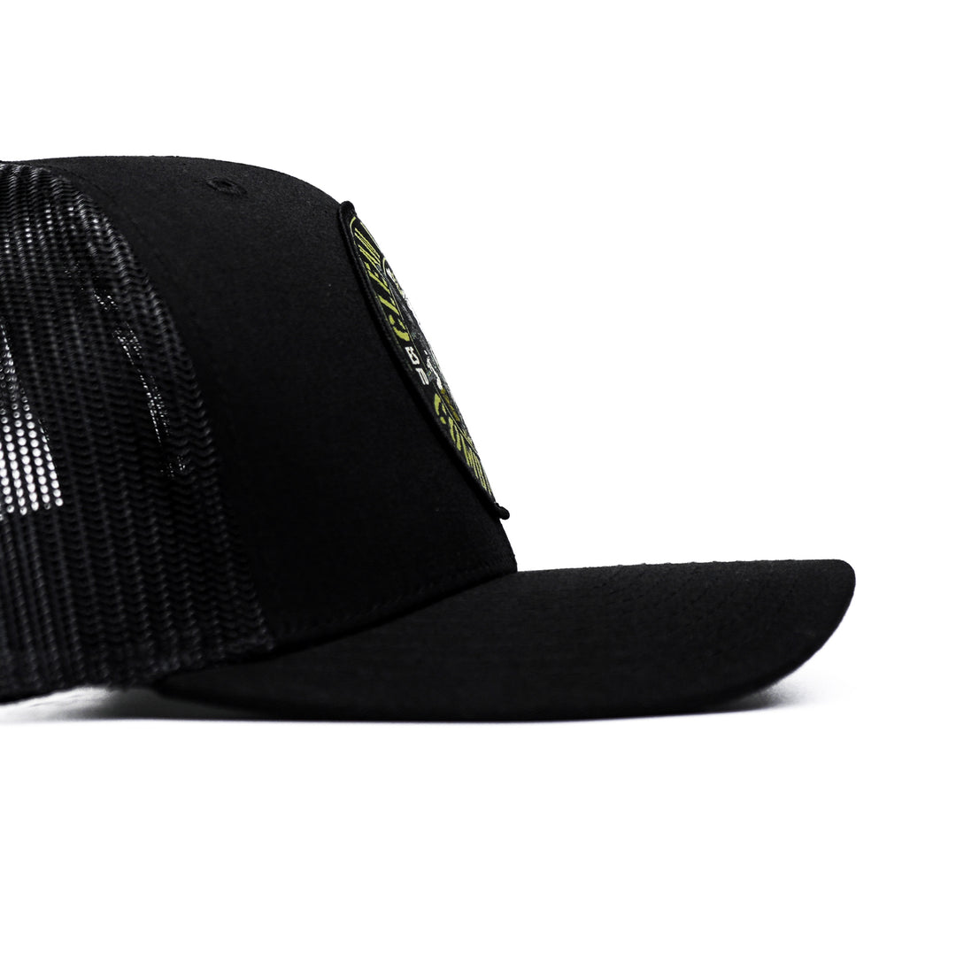 A black mid-profile mesh snapback with a patch that says “Clean up crew” in yellow #color_black-black