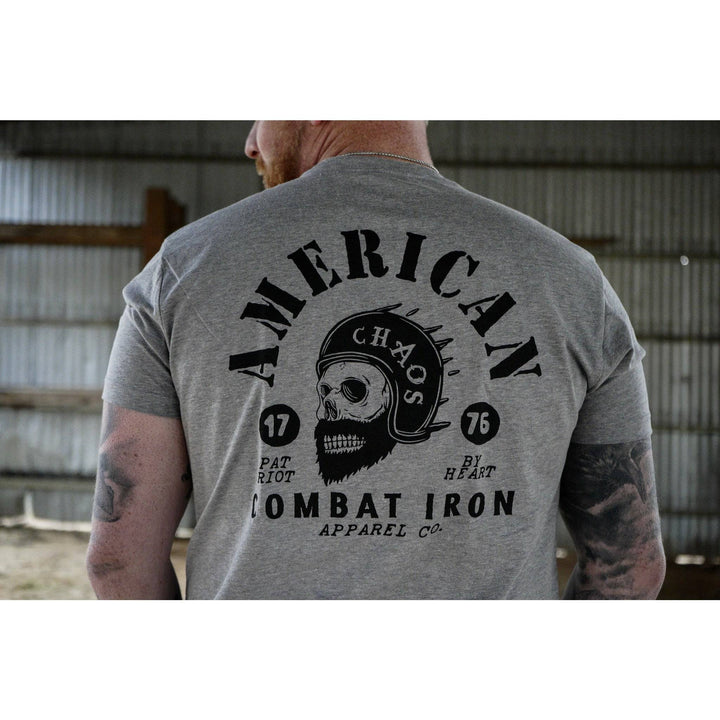 A men’s t-shirt with the words “American chaos” with a bearded skull in the front and the words “Combat Iron” below the skull #color_gray