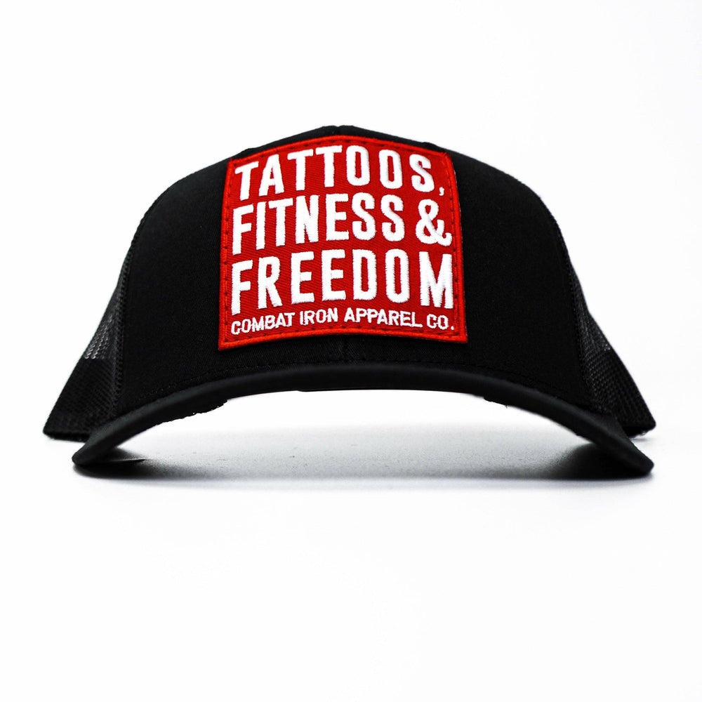 A black mid-profile mesh snapback with a red patch saying “Tattoos, fitness & freedom” in white letters #color_black-black