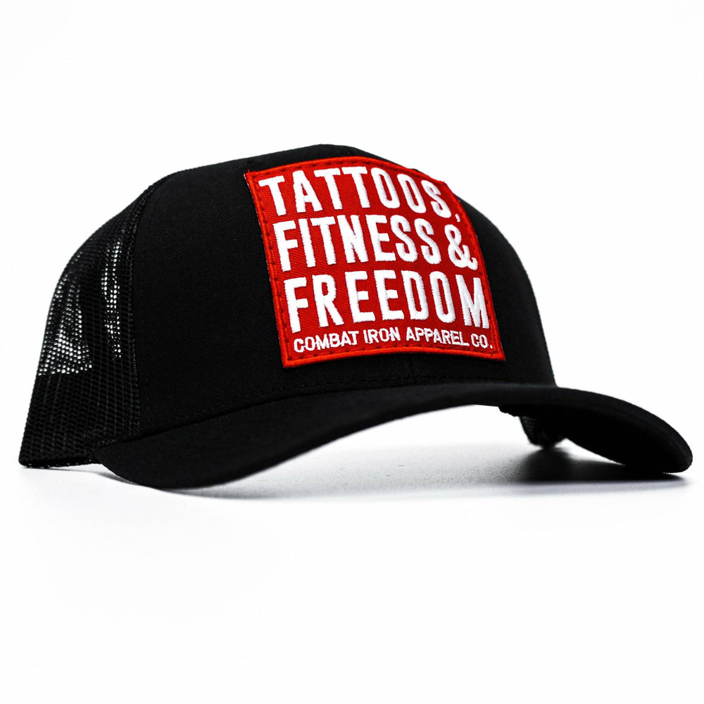 A black mid-profile mesh snapback with a red patch saying “Tattoos, fitness & freedom” in white letters #color_black-black