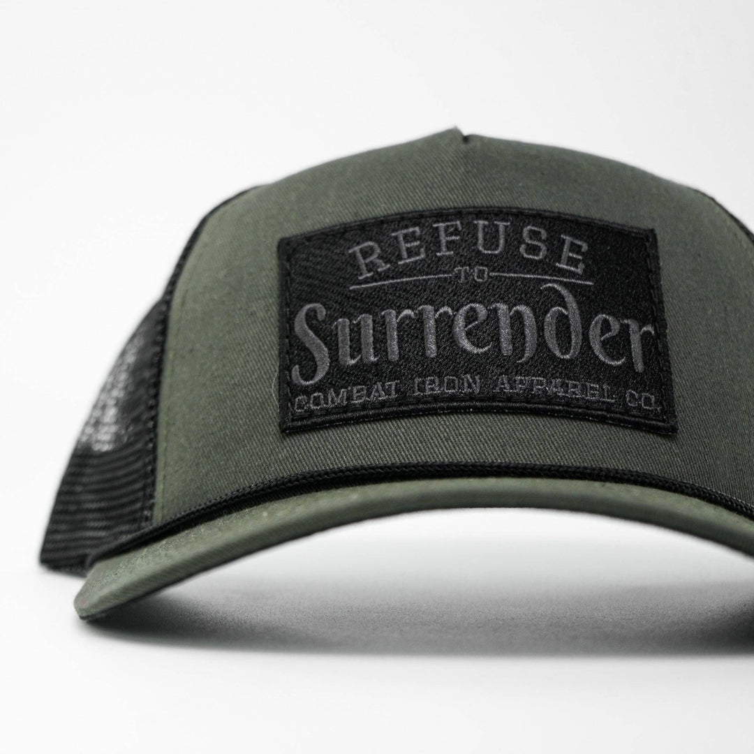 A camo retro rope snapback with a black patch that says “Refuse to surrender” #color_military-green-black