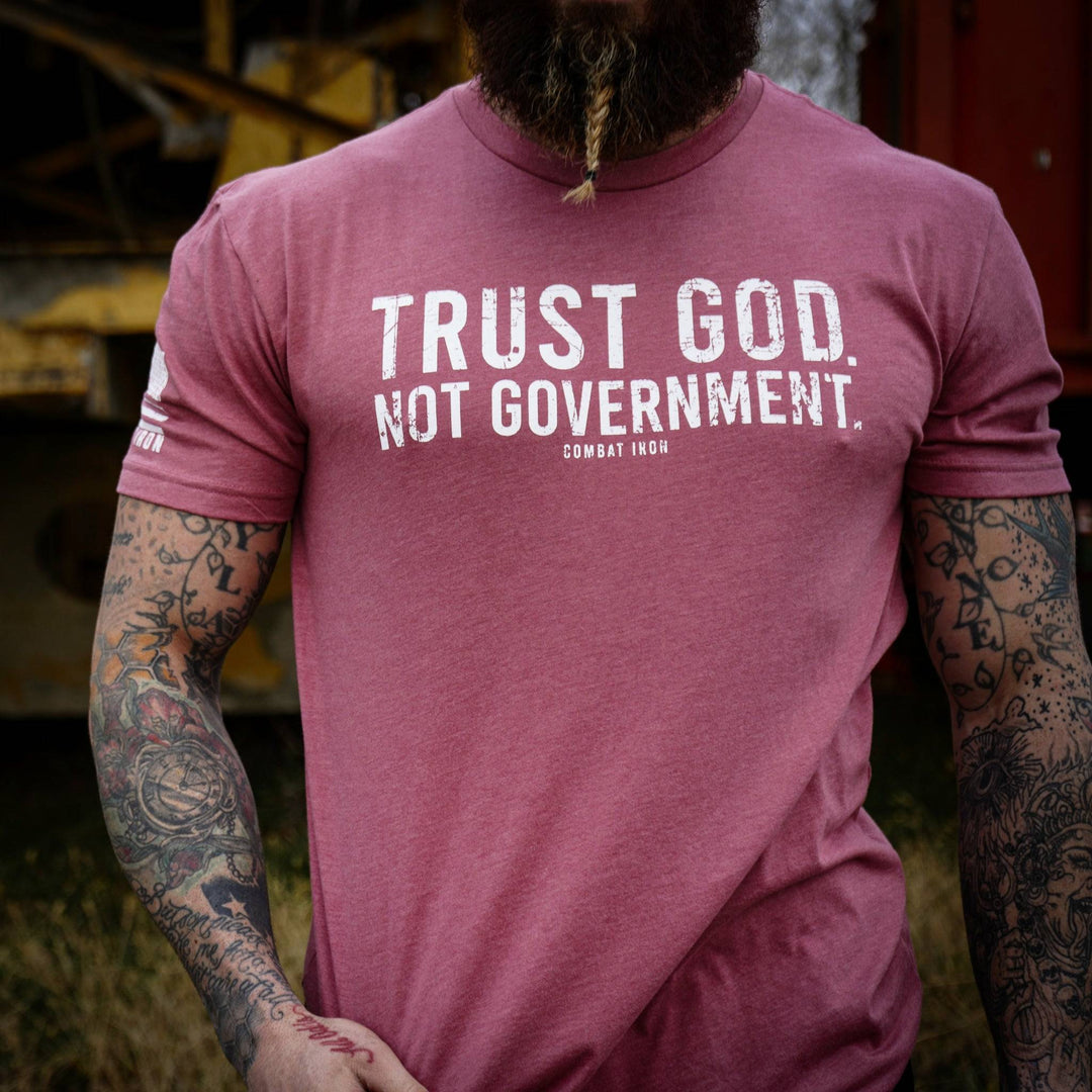 Men’s black t-shirt with the message “Trust God. Not government.” with letters and a American flag on the sleeve #color_muave